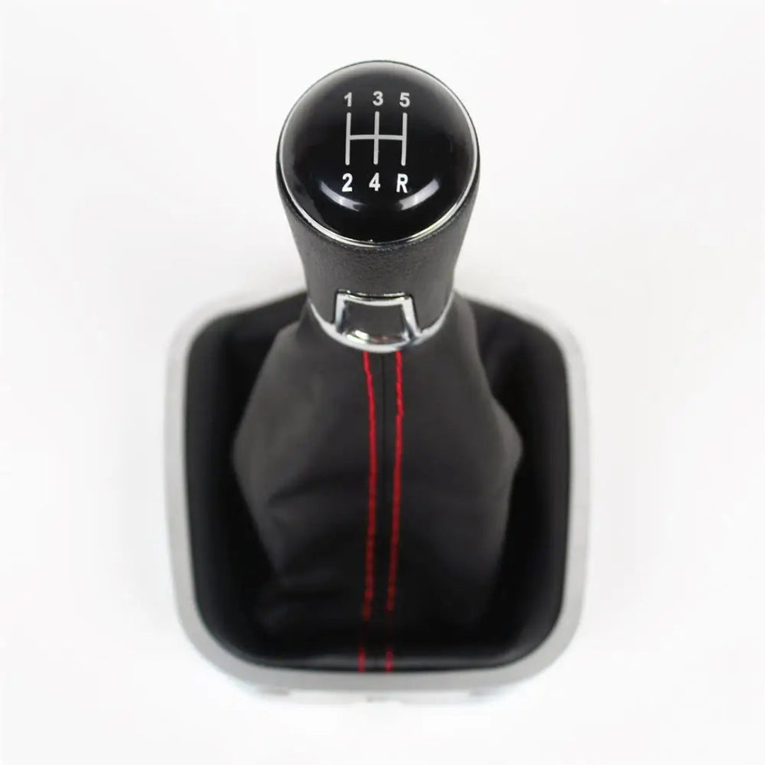 Pommeau de vitesse Polo avec la marche arrière à droite et soufflet couleur noir avec couture rouge.