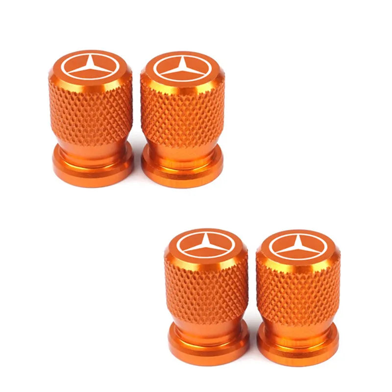 Bouchon de valve Mercedes de couleur orange, avec le logo Mercedes présent sur le haut du bouchon.