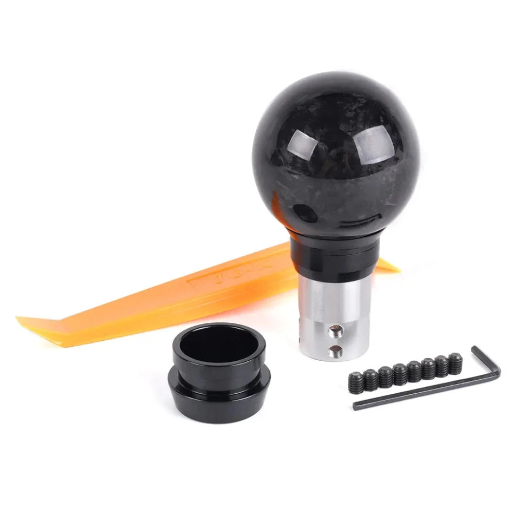 Pommeau de vitesse Honda couleur carbone, accompagné de ses accessoires pour le montage.