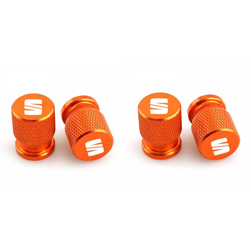 Bouchon de valve Seat avec partie granulé et logo Seat sur le bouchon, de couleur orange.