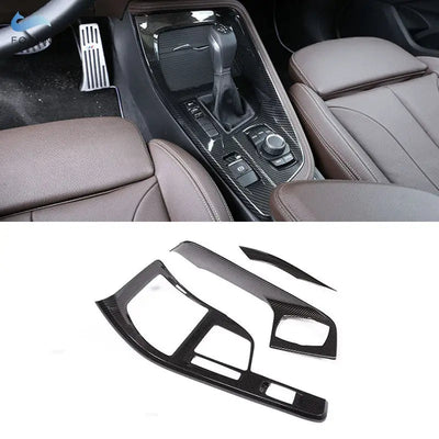 Garniture console centrale carbone montée sur BMW X1 F48 autour du sélecteur et de l'iDrive, avec les trois pièces seules