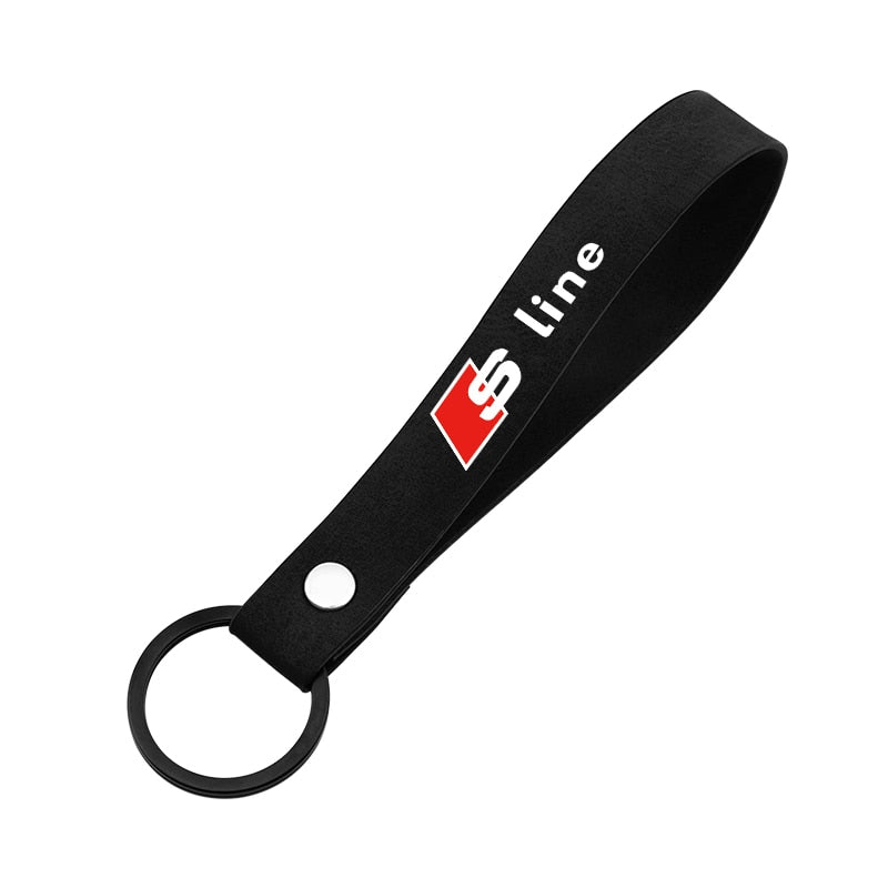Porte-clés en sangle noire au logo Audi S line, fourni avec les bouchons de valve