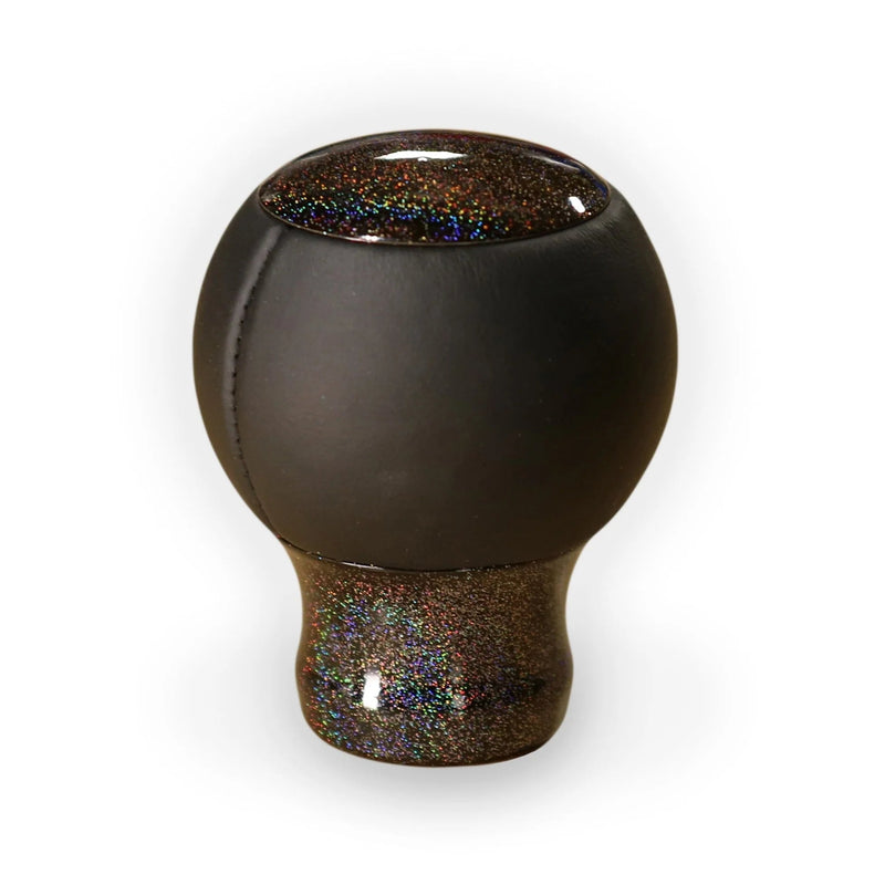 Pommeau de vitesse multicolore monté sur le levier, sphère noire et embase à paillettes irisées