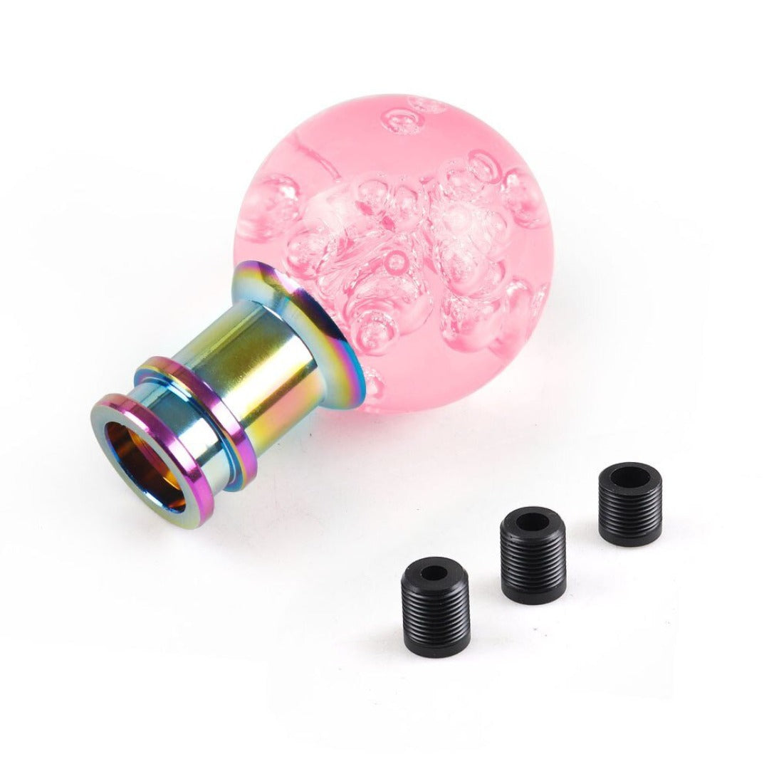 Pommeau de vitesse original en forme de boule, de couleur rose.